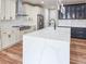 Stylish kitchen featuring a large island with white countertop and sleek stainless steel appliances at 5550 Wetlands Dr, Longmont, CO 80504
