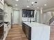 Well-appointed kitchen featuring an island, white cabinets, and modern light fixtures at 5550 Wetlands Dr, Longmont, CO 80504