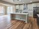Modern kitchen with white cabinets, stainless steel appliances, and a large center island at 5550 Wetlands Dr, Longmont, CO 80504