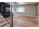 Open-concept living room showcasing wood floors, stairs, and modern finishes at 5550 Wetlands Dr, Longmont, CO 80504