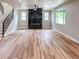 Spacious living room featuring wood floors, a fireplace, and large windows at 5550 Wetlands Dr, Longmont, CO 80504