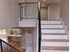Staircase featuring a metal railing and wood steps, connecting multiple floors in the home at 5550 Wetlands Dr, Longmont, CO 80504