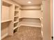 A large walk-in closet has carpeted floors and many shelves for optimal storage and organization at 5550 Wetlands Dr, Longmont, CO 80504