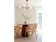 Dining room with wood table, modern lighting, and view of the backyard at 1020 Stuart St, Denver, CO 80204