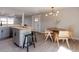 Dining area features butcher block island, modern lighting and open plan design at 1020 Stuart St, Denver, CO 80204