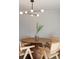 Bright dining room with modern light fixture and dining table with seating for four at 1020 Stuart St, Denver, CO 80204