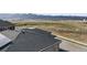 Aerial view of home featuring new roof, solar panels, and stunning mountain views in the distance at 9694 Meeker St, Littleton, CO 80125
