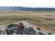 Wide aerial shot showing the layout of the community's housing, roads, and open spaces with a mountain backdrop at 9694 Meeker St, Littleton, CO 80125