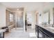 Stylish bathroom with a tiled walk-in shower and a vanity with stone countertops, blending elegance and functionality at 9694 Meeker St, Littleton, CO 80125