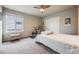 Bright bedroom with a ceiling fan, exercise equipment, and a large window overlooking the neighborhood at 9694 Meeker St, Littleton, CO 80125