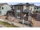 View of a modern two-story home with brick and siding exterior, featuring a covered porch and landscaped yard at 9694 Meeker St, Littleton, CO 80125