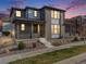 Charming two-story home featuring a covered porch, brick accents, and well-maintained landscaping under a beautiful evening sky at 9694 Meeker St, Littleton, CO 80125