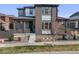 Charming two-story home featuring brick and siding, a cozy front porch, and modern landscaping at 9694 Meeker St, Littleton, CO 80125