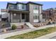 Charming two-story home featuring brick and siding, a cozy front porch, and modern landscaping at 9694 Meeker St, Littleton, CO 80125