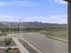 Exterior view from a window showing a cul-de-sac with distant mountain views at 9694 Meeker St, Littleton, CO 80125