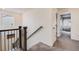 Upstairs hallway with a carpet runner that directs attention to bright bedrooms at 9694 Meeker St, Littleton, CO 80125