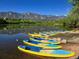 Scenic view of the lake with paddleboards on the shore and the mountains in the background at 9694 Meeker St, Littleton, CO 80125