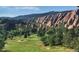 Scenic view of a golf course nestled against dramatic red rock formations and lush green mountains at 9694 Meeker St, Littleton, CO 80125