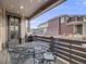 Inviting covered patio with outdoor seating and a grill, perfect for relaxing and entertaining guests at 9694 Meeker St, Littleton, CO 80125