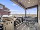 Cozy covered patio with grill and comfortable seating, offering peaceful views of the surrounding neighborhood at 9694 Meeker St, Littleton, CO 80125