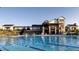 Community clubhouse with a pool, chairs and shade structures offering recreational amenities at 9694 Meeker St, Littleton, CO 80125
