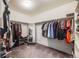 Spacious walk-in closet features ample hanging space, shelving, and a full-length mirror for convenient dressing at 9694 Meeker St, Littleton, CO 80125