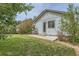 Backyard view of house with a small patio and landscaped yard at 162 N Eaton Park St, Aurora, CO 80018