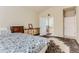 Bedroom featuring a large patterned rug, access to the ensuite bathroom, and bright neutral paint at 162 N Eaton Park St, Aurora, CO 80018