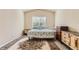 Cozy bedroom with a patterned rug, window view, and traditional furniture at 162 N Eaton Park St, Aurora, CO 80018