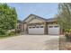 Inviting home exterior showcasing a well-manicured lawn, stone accents, and a three car garage at 162 N Eaton Park St, Aurora, CO 80018