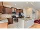 Modern kitchen with stainless steel appliances, granite countertops, and dark wood cabinets at 162 N Eaton Park St, Aurora, CO 80018