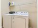 Laundry room featuring white washer and dryer with wire shelving above at 162 N Eaton Park St, Aurora, CO 80018