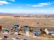 An aerial view showcases a neighborhood with mountain views, solar panels, and diverse home styles at 7131 Shavano Cir, Frederick, CO 80504