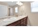 Bathroom featuring dual sinks, large mirror, and modern fixtures at 7131 Shavano Cir, Frederick, CO 80504