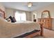 Comfortable bedroom featuring a ceiling fan, large window, and classic wooden furniture at 7131 Shavano Cir, Frederick, CO 80504