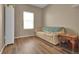 Cozy living room featuring wood floors, neutral walls, a large window, and comfortable seating at 7131 Shavano Cir, Frederick, CO 80504