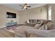 Comfortable living room with a large sectional sofa, media console, and a decorative rug on wood floors at 7131 Shavano Cir, Frederick, CO 80504