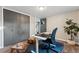 Home office featuring a standing desk, blue rug and a spacious closet at 5993 Field St, Arvada, CO 80004