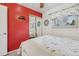 Cozy bedroom with red accent wall, sliding closet, and natural light at 1164 W 101St Pl, Northglenn, CO 80260