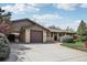 Charming single-story home with a brick facade, attached garage, mature landscaping, and a well-kept lawn at 1164 W 101St Pl, Northglenn, CO 80260