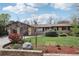 Charming single-story home with brick accents, a well-manicured lawn, and mature trees at 1164 W 101St Pl, Northglenn, CO 80260