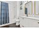 A renovated bathroom shows off the updated vanity, framed mirror and coordinated shower curtain at 4085 S Crystal Cir # 101, Aurora, CO 80014