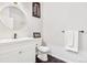 Modern bathroom features round mirror, new white vanity and hexagonal tile flooring at 4085 S Crystal Cir # 101, Aurora, CO 80014