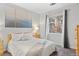 Bright bedroom features a large window, neutral décor, and cozy carpet at 4085 S Crystal Cir # 101, Aurora, CO 80014