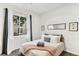 Bright bedroom features a large window, neutral décor, and cozy carpet at 4085 S Crystal Cir # 101, Aurora, CO 80014