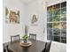 Charming dining room with a black table set, natural light, and decorative artwork at 4085 S Crystal Cir # 101, Aurora, CO 80014
