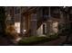 Multi-story condominium building with stone facade, wood stairs, and green landscaping at 4085 S Crystal Cir # 101, Aurora, CO 80014