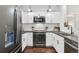 Modern kitchen featuring stainless steel appliances, white cabinets, and updated countertops at 4085 S Crystal Cir # 101, Aurora, CO 80014