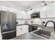 Modern kitchen features stainless steel appliances, sleek countertops, and ample white cabinet storage space at 4085 S Crystal Cir # 101, Aurora, CO 80014