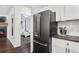Kitchen with stainless steel refrigerator and view into bedroom at 4085 S Crystal Cir # 101, Aurora, CO 80014